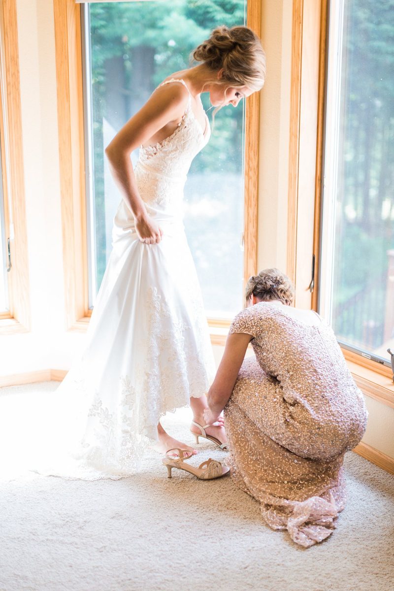 Bride getting dressed during full-day wedding shoot. 
