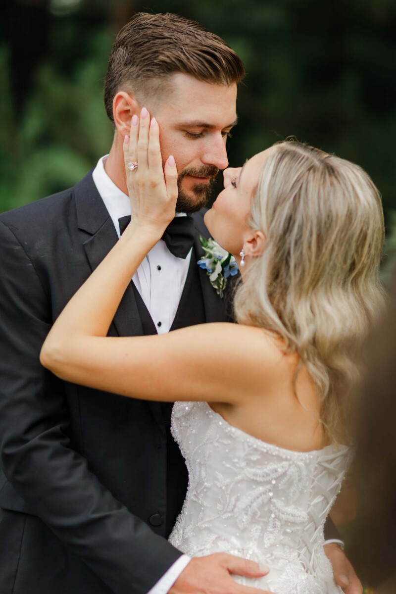 Elegant Wisconsin wedding couple sharing a tender moment outdoors.