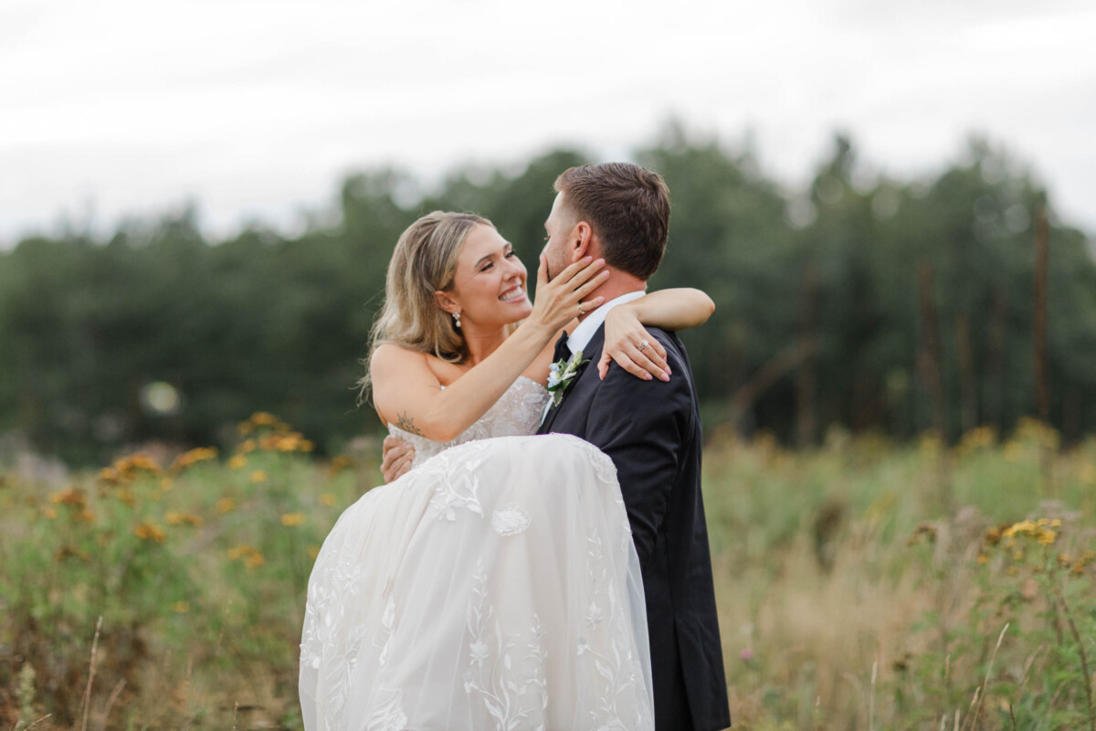 Bride and groom embracing outdoors near Minocqua, Wisconsin.