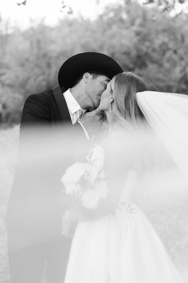 Bride and groom share a tender moment outdoors in rural Utah.