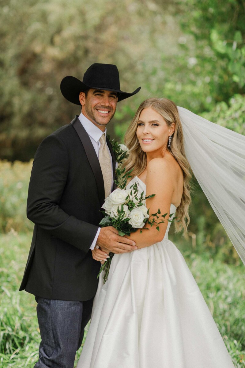 Wedding couple in rural Utah with greenery background.