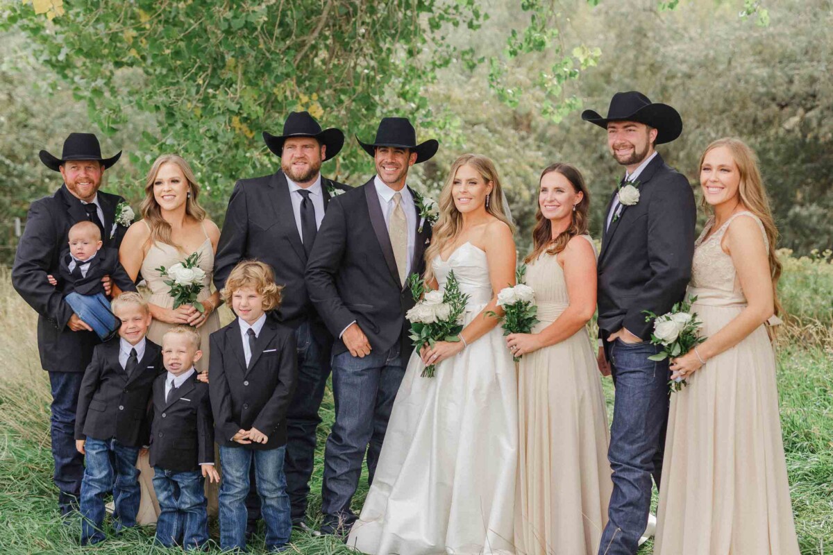 Wedding group photo of the bride, groom, and family outdoors in Utah.