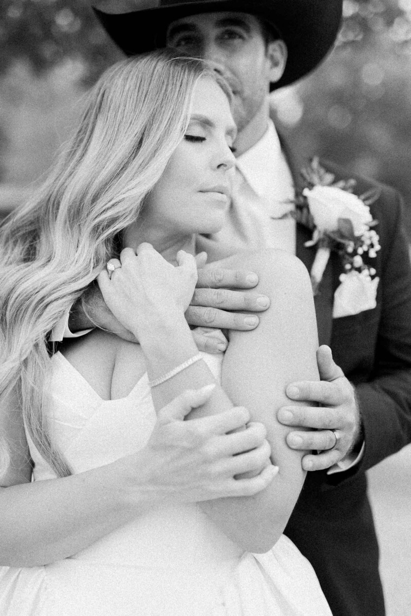Beautiful couple embracing outdoors during fall wedding in Utah.