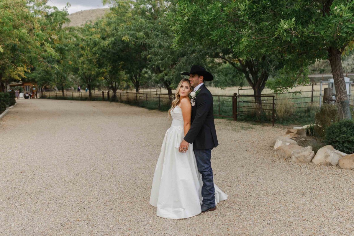 Beautiful couple embracing outdoors during fall wedding in Utah.