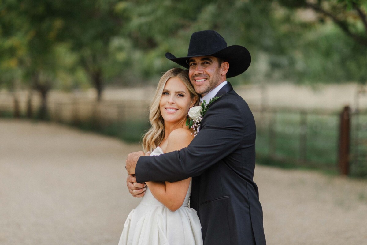 Happy couple embracing outdoors in fall setting.