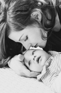 mom kissing baby photo