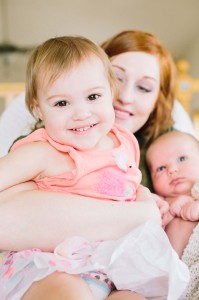smiling little girl on mother's lap photo