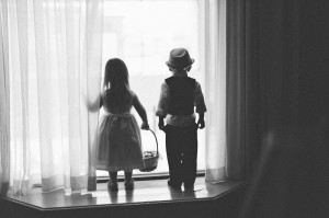 flower girl and ring bearer looking out window photo