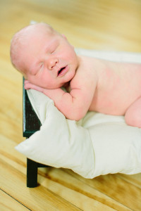 Baby sleeping on doll bed photo