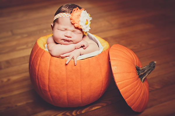 newborn baby in pumpkin halloween