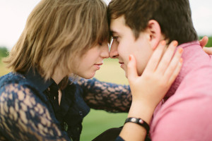 Kissing in a field engagement photo ideas