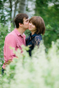 Kissing in a field engagement photo ideas