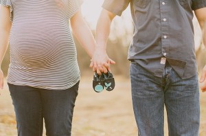 Maternity photos with husband baby boy shoes