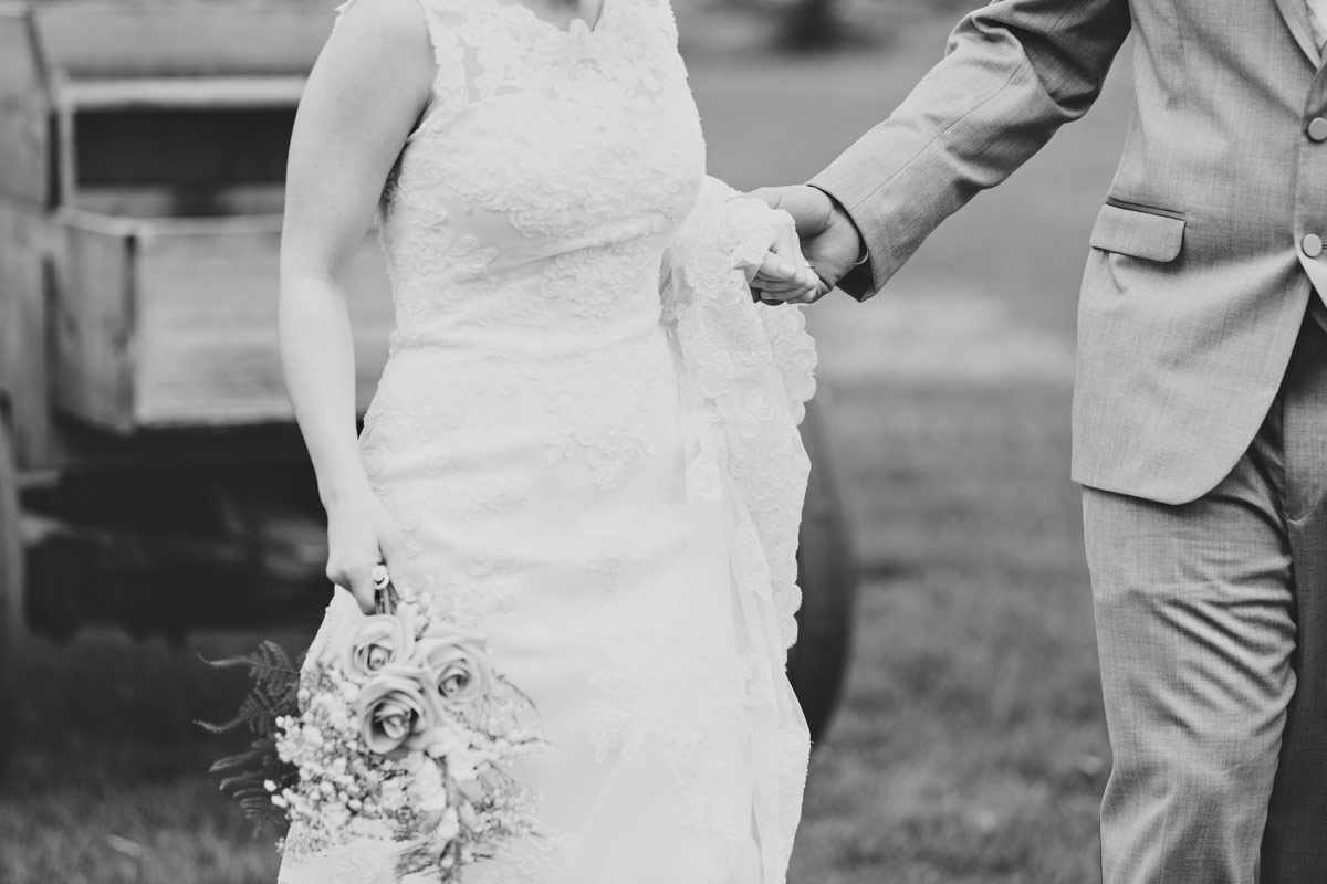 bride and groom holding hands & walking
