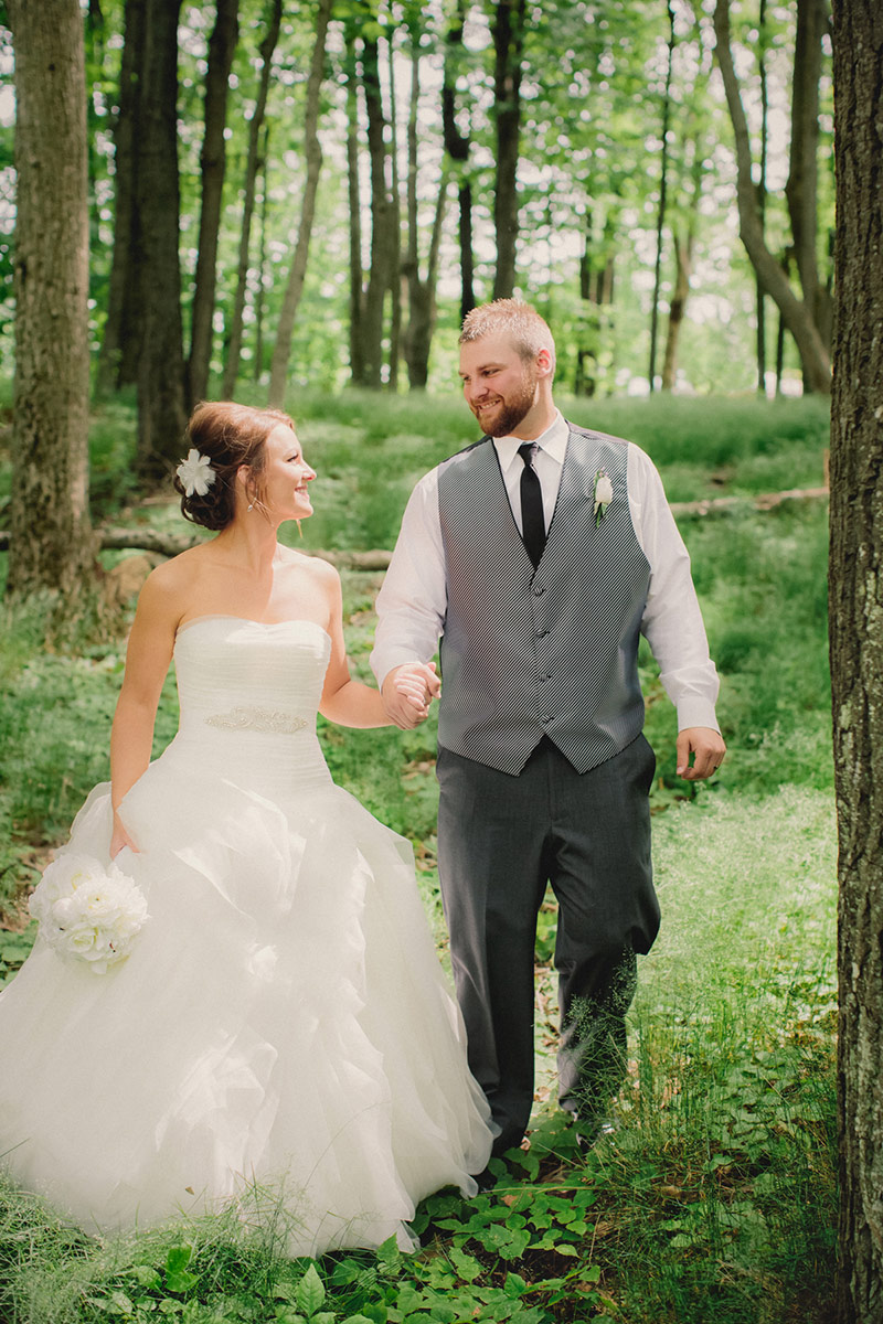 wedding couple on rib mountain wedding wausau walking through woods photo james stokes photography