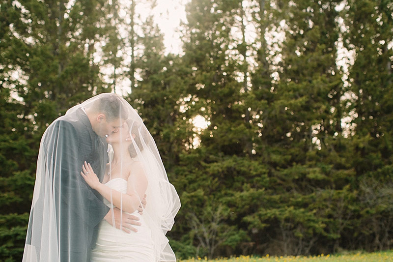 kissing at sunset wedding photo