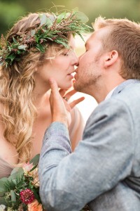 Bride and groom in canoe on lake in northern wisconsin