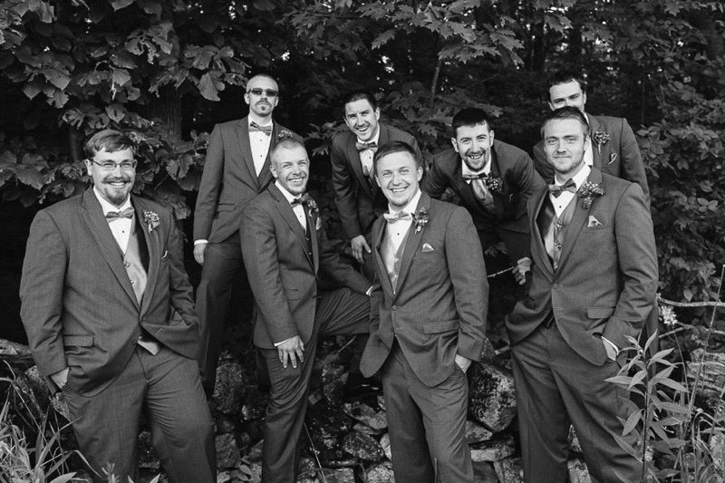 groomsmen in woods black and white candid wedding photos