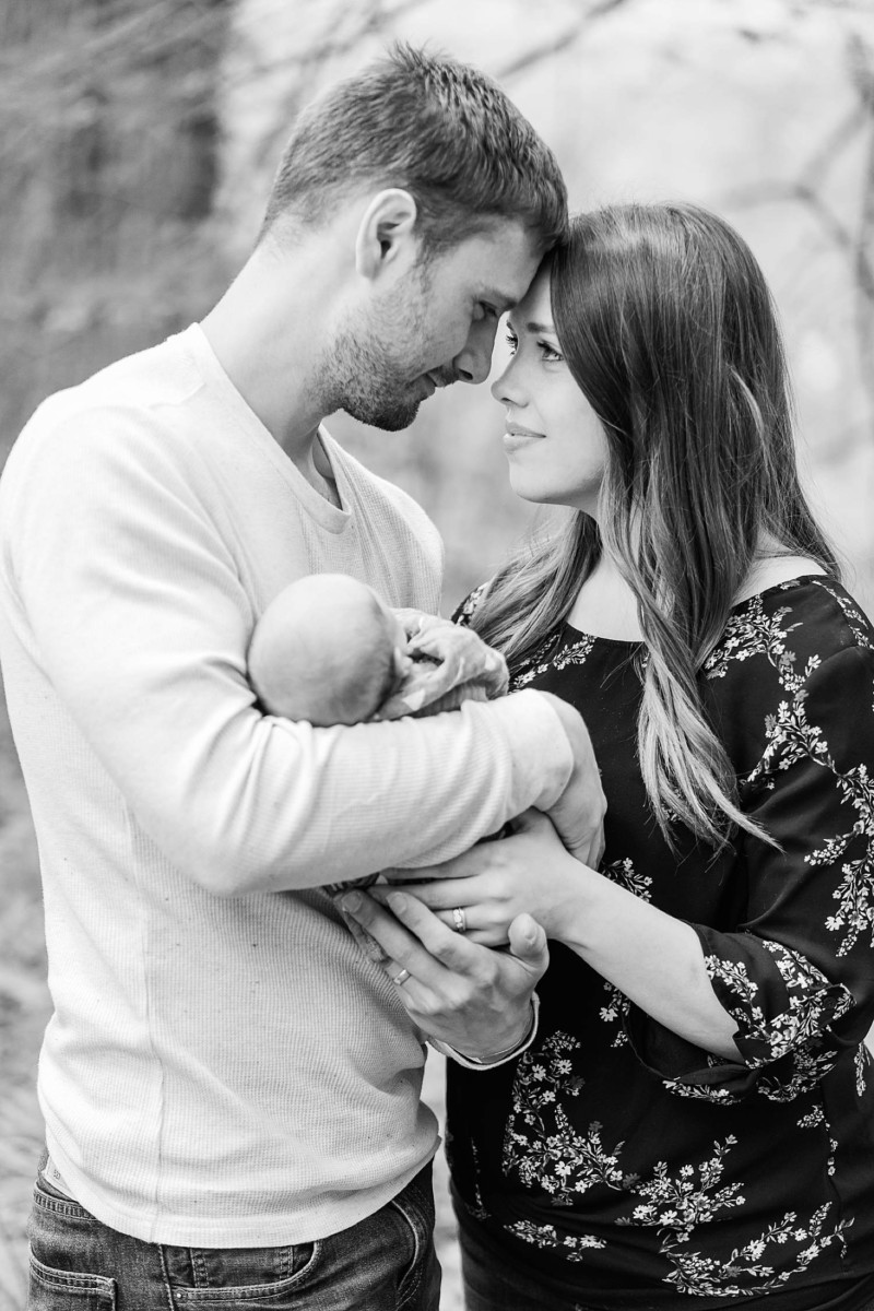 Husband and wife holding baby