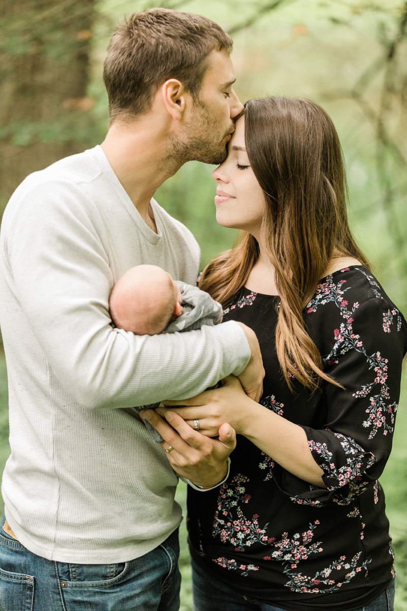 Husband and wife holding baby